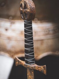 closeup photo of black hilt and brown sword